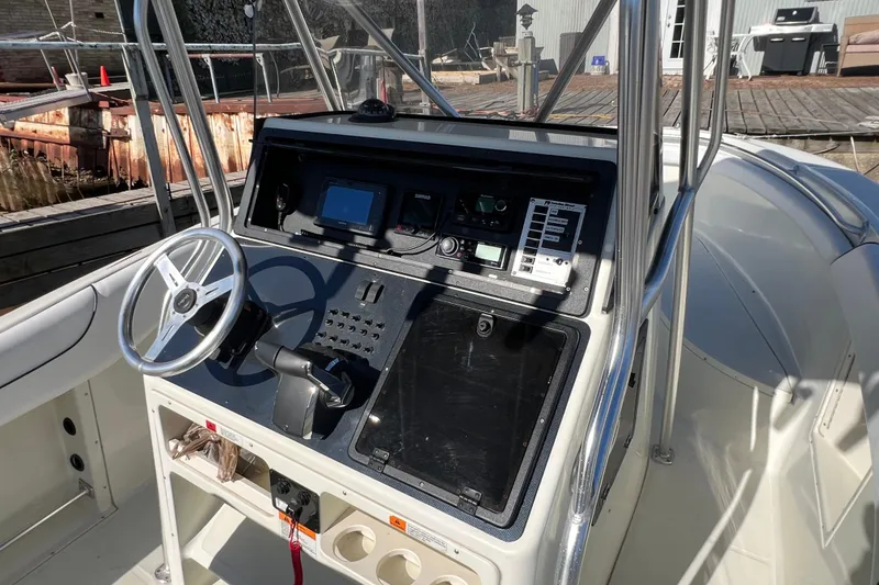 Slide: The Image of 2001 Hydra-Sports Vector 2600 CC boat console with steering wheel and navigation controls. - 7