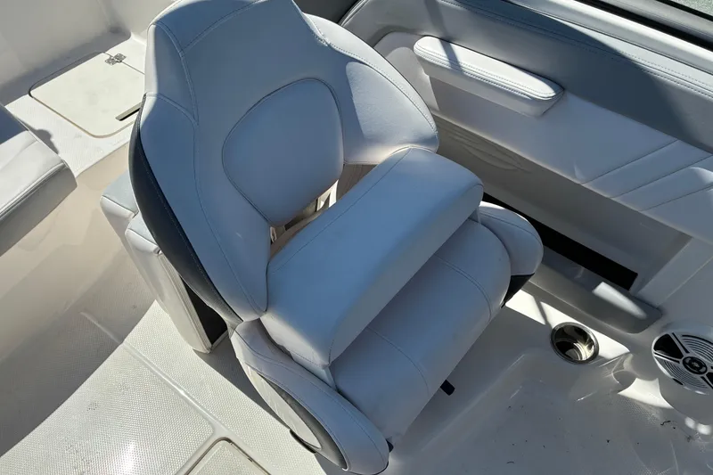Slide: The Image of 2019 Chaparral 21 H2O Sport boat interior with white cushioned seating. - 10