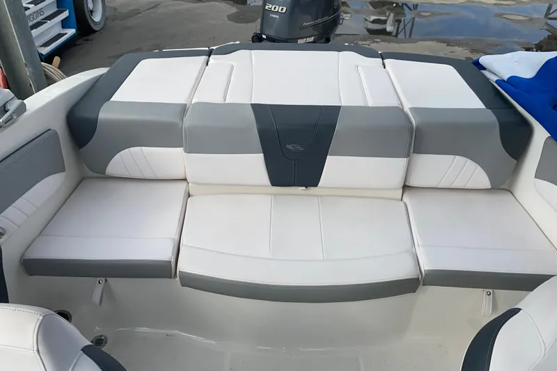 Slide: The Image of 2019 Chaparral 21 H2O Sport boat interior with gray and white seating. - 12