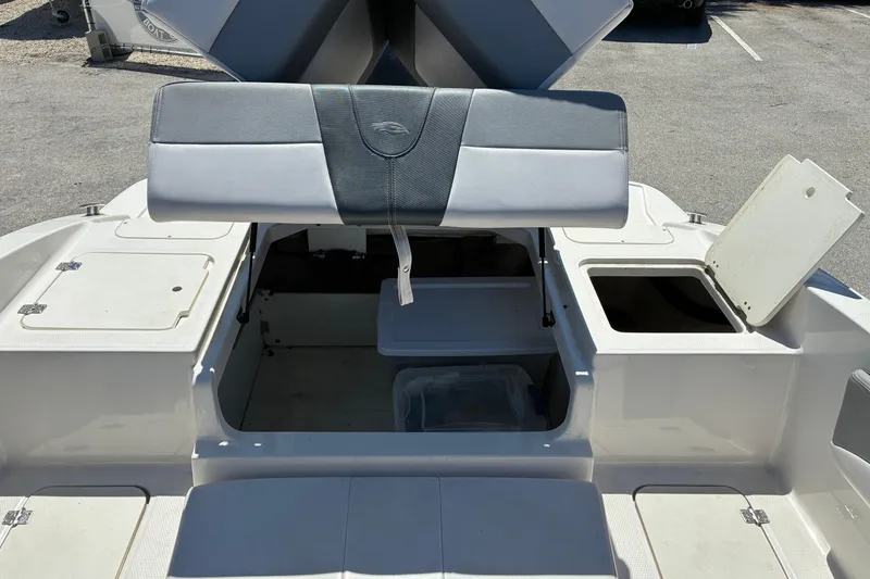 Slide: The Image of 2019 Chaparral 21 H2O Sport boat interior with open storage compartments. - 14