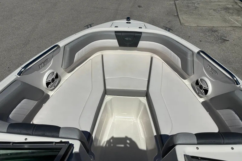 Slide: The Image of 2019 Chaparral 21 H2O Sport boat interior with cushioned seating and speakers. - 15