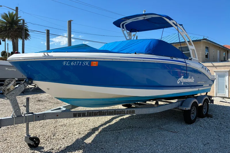 Slide: The Image of 2019 Chaparral 21 H2O Sport boat on trailer, blue and white, sunny day. - 4