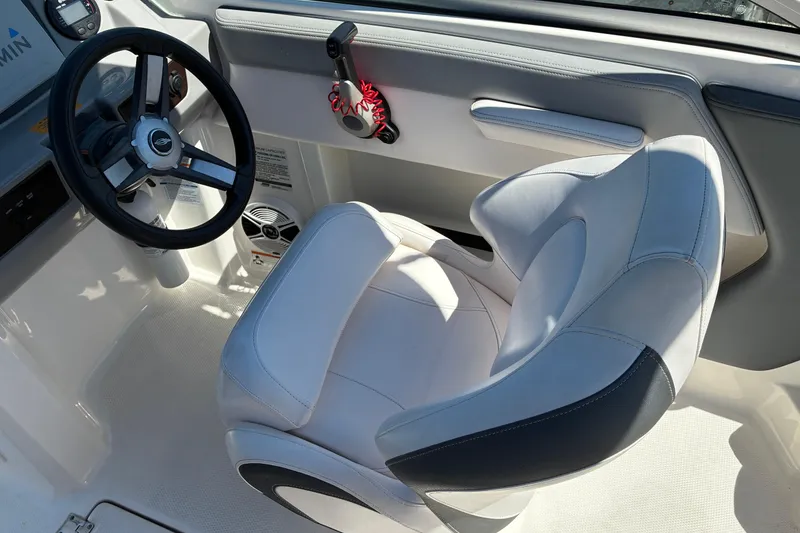 Slide: The Image of Interior of 2019 Chaparral 21 H2O Sport boat with steering wheel and seat. - 9