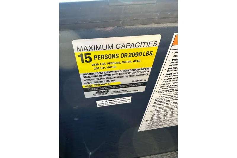 Slide: The Image of Sweetwater 2386 SB 2022 boat capacity label, 15 persons or 2090 lbs limit. - 12