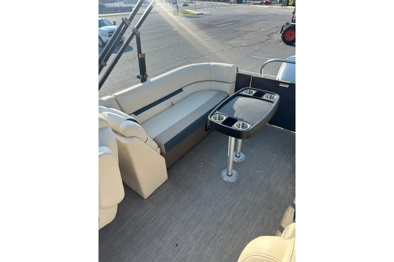 Slide: The Image of 2022 Sweetwater 2386 SB pontoon boat interior with seating and table. - 14