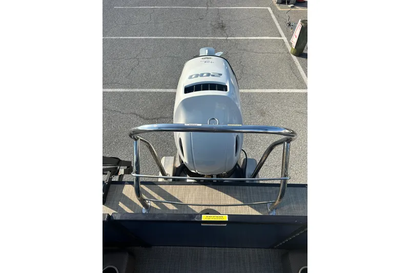 Slide: The Image of 2022 Sweetwater 2386 SB boat with powerful outboard motor in a parking lot. - 16