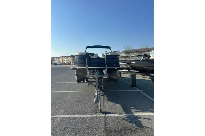 Slide: The Image of 2022 Sweetwater 2386 SB pontoon boat parked in a lot under clear blue sky. - 3