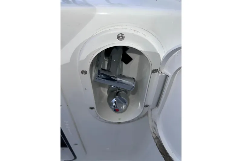 Slide: The Image of Beneteau Oceanis 30.1 2024 yacht detail showing a chrome handle in a recessed compartment. - 12