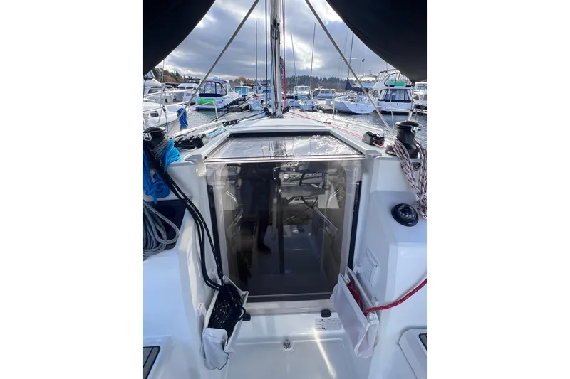Slide: The Image of 2024 Beneteau Oceanis 30.1 sailboat cockpit view at marina, showcasing sleek design. - 13