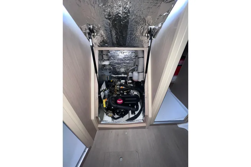 Slide: The Image of Engine compartment of 2024 Beneteau Oceanis 30.1 sailboat, showcasing mechanical components. - 15