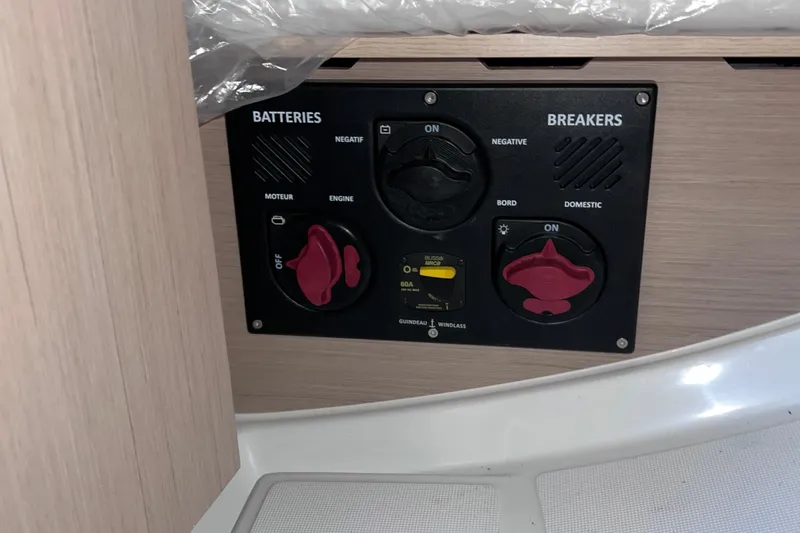 Slide: The Image of Control panel on 2024 Beneteau Oceanis 30.1 yacht, featuring battery and breaker switches. - 17