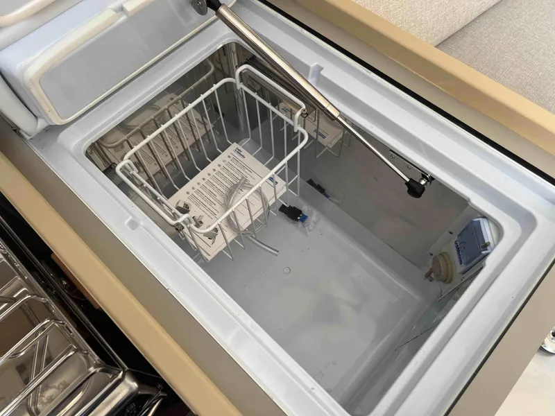 Slide: The Image of Interior view of a 2024 Beneteau Oceanis 30.1 yacht refrigerator compartment. - 23