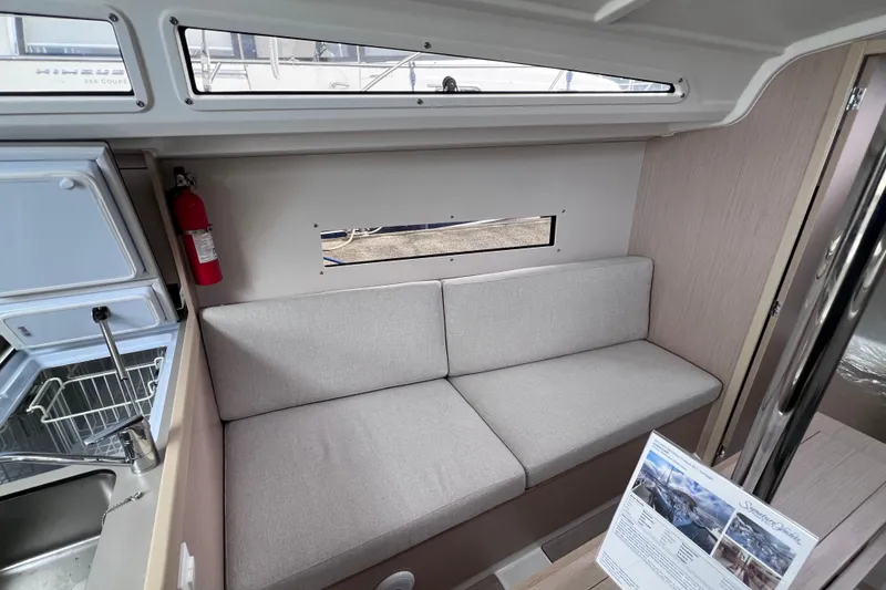 Slide: The Image of Interior of 2024 Beneteau Oceanis 30.1 yacht with gray sofa and window view. - 26