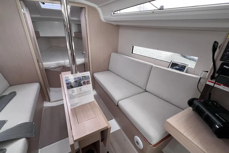Slide: The Image of Interior of 2024 Beneteau Oceanis 30.1 yacht, featuring modern seating and cabin area. - 27
