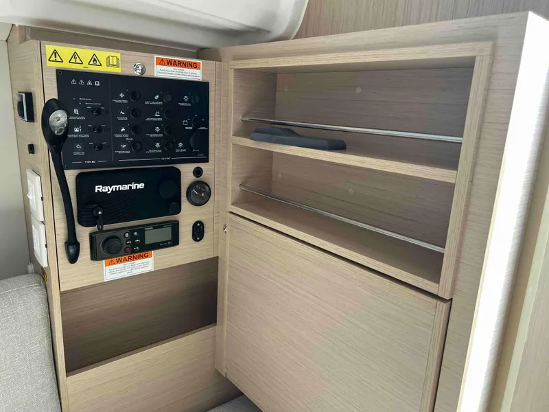 Slide: The Image of Control panel and storage shelves on 2024 Beneteau Oceanis 30.1 yacht. - 28