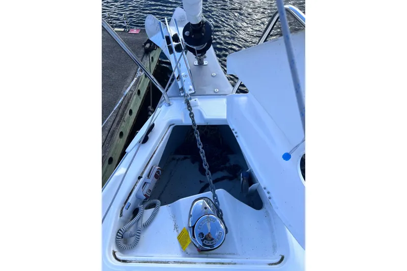 Slide: The Image of Anchor system on a 2024 Beneteau Oceanis 30.1 sailboat, docked by the water. - 6