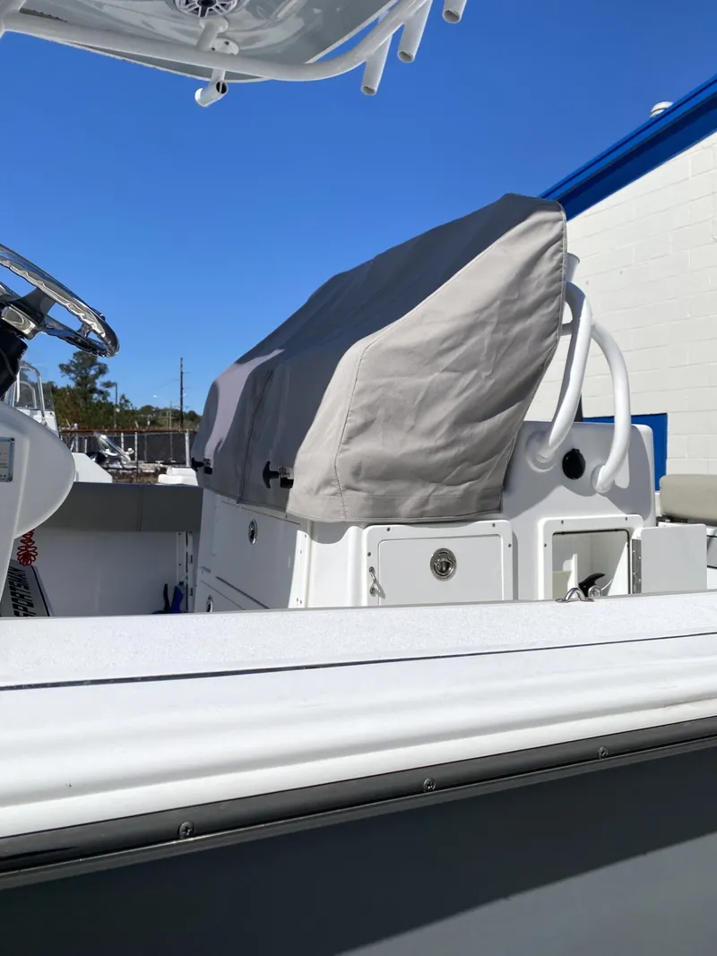 Slide: The Image of 2021 Sportsman Open 282 Center Console with cover at dock. - 2