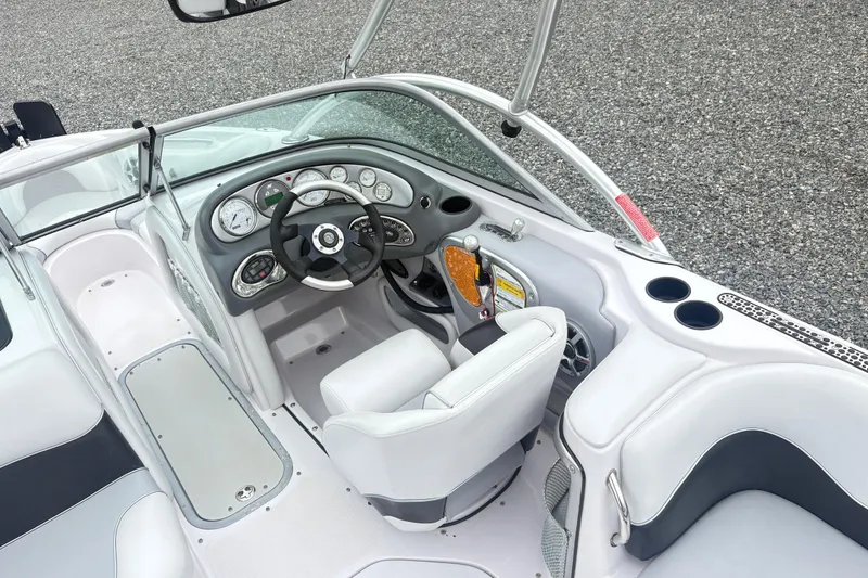 Slide: The Image of 2005 Correct Craft Nautique boat interior with steering wheel, dashboard, and seating. - 10