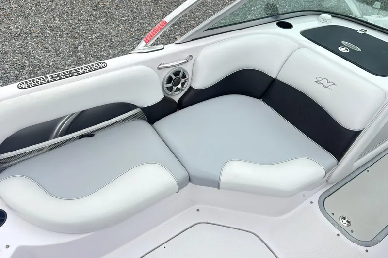 Slide: The Image of 2005 Correct Craft Nautique boat interior with white and black seating. - 12