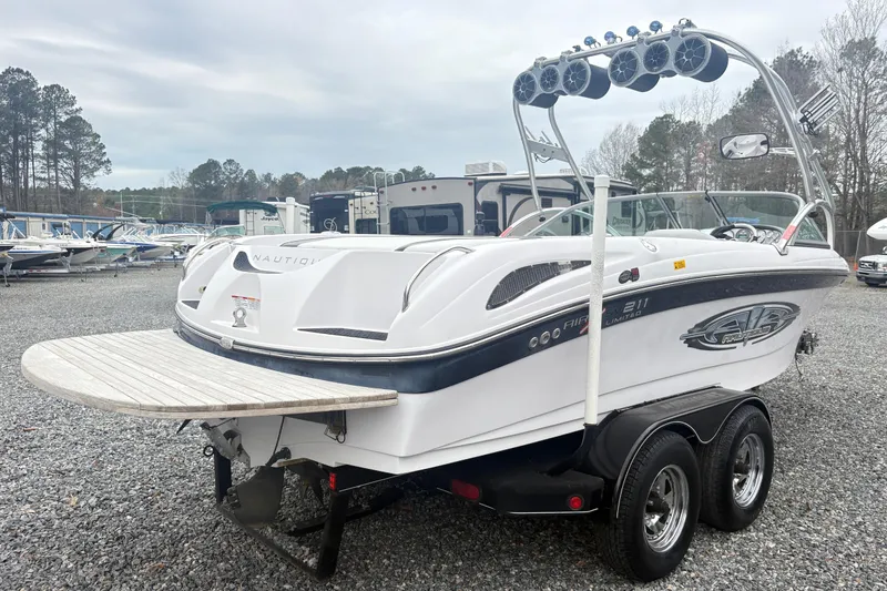 Slide: The Image of 2005 Correct Craft Nautique boat on trailer, featuring wakeboard tower and speakers. - 3