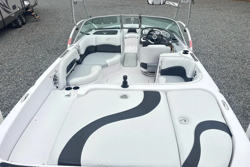 Slide: The Image of 2005 Correct Craft Nautique boat interior with white and gray seating, sleek design. - 7