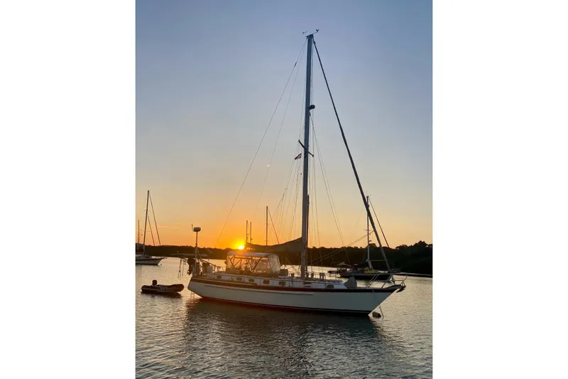The Image of Sailboat Endeavour 40 CC, 1984 model, anchored at sunset on calm waters. - 0