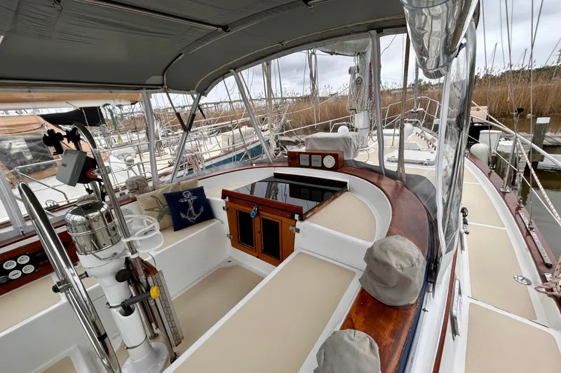 Slide: The Image of 1984 Endeavour 40 CC sailboat cockpit with steering wheel, seating, and nautical decor. - 10