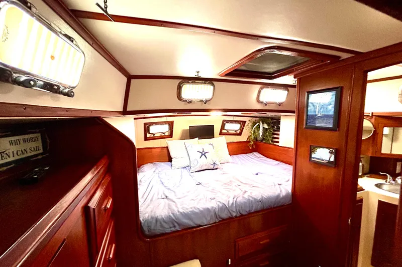 Slide: The Image of Cozy cabin interior of 1984 Endeavour 40 CC sailboat with wood finish and comfortable bedding. - 11