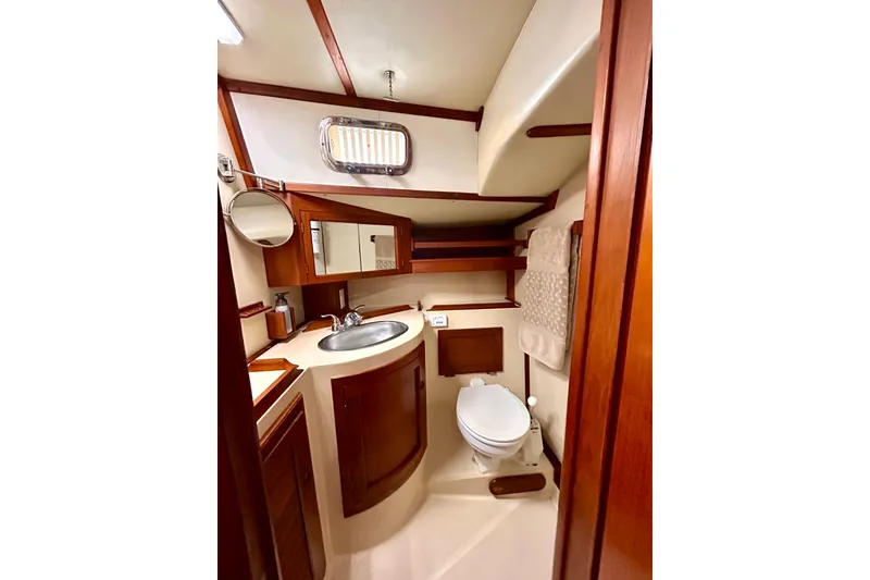 Slide: The Image of 1984 Endeavour 40 CC yacht bathroom with wooden cabinetry and compact design. - 12