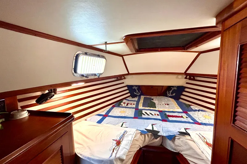 Slide: The Image of Cozy cabin interior of 1984 Endeavour 40 CC sailboat with nautical-themed bedding. - 13