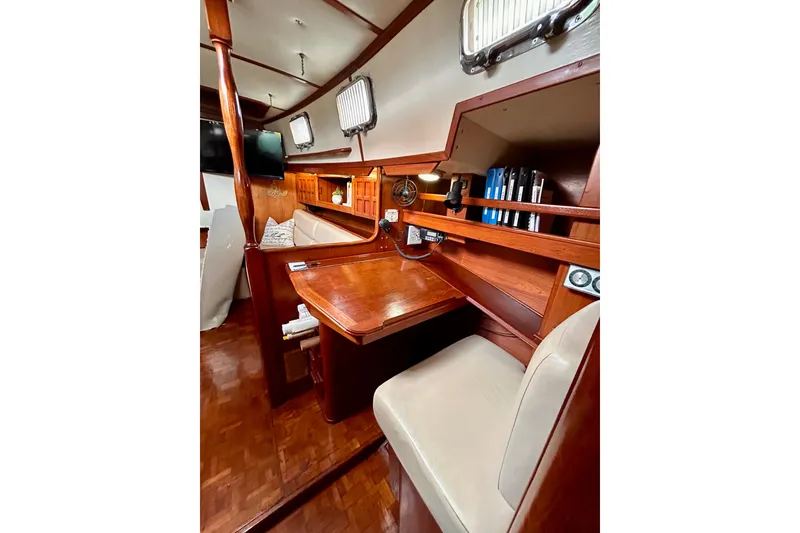 Slide: The Image of Interior of 1984 Endeavour 40 CC sailboat with wooden desk and seating area. - 19