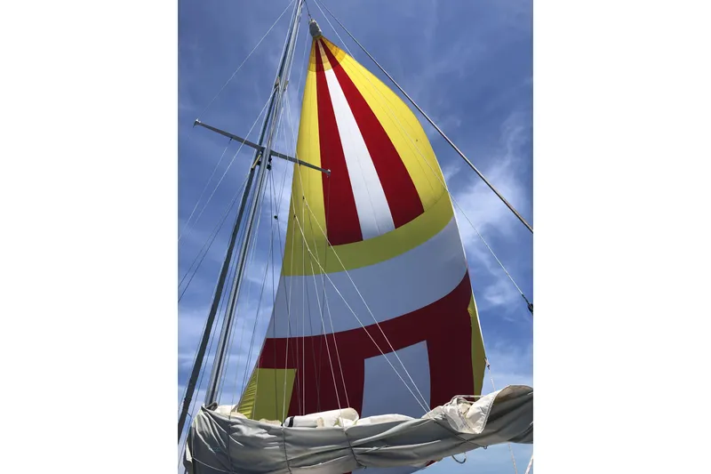 Slide: The Image of Colorful sail on 1984 Endeavour 40 CC yacht against clear blue sky. - 2