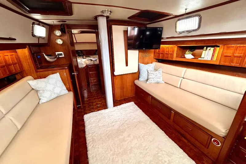 Slide: The Image of Luxurious interior of 1984 Endeavour 40 CC yacht with cozy seating and elegant wood finishes. - 20
