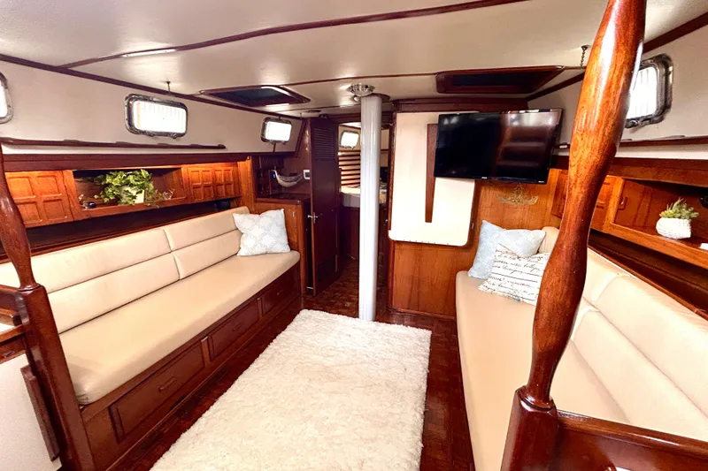 Slide: The Image of Interior of 1984 Endeavour 40 CC yacht with cozy seating and elegant wood finishes. - 21