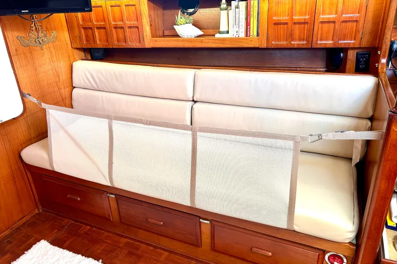 Slide: The Image of Interior of 1984 Endeavour 40 CC sailboat with cushioned seating and wooden cabinetry. - 23
