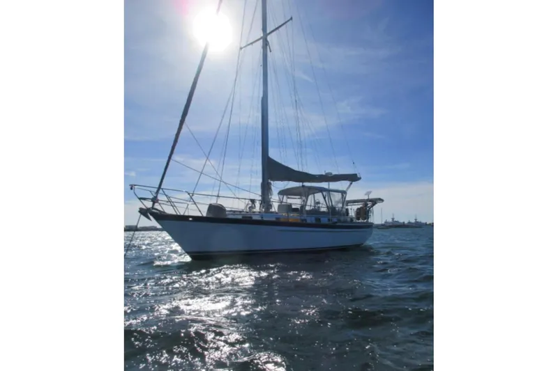 Slide: The Image of 1984 Endeavour 40 CC sailboat on open water under clear blue sky. - 3