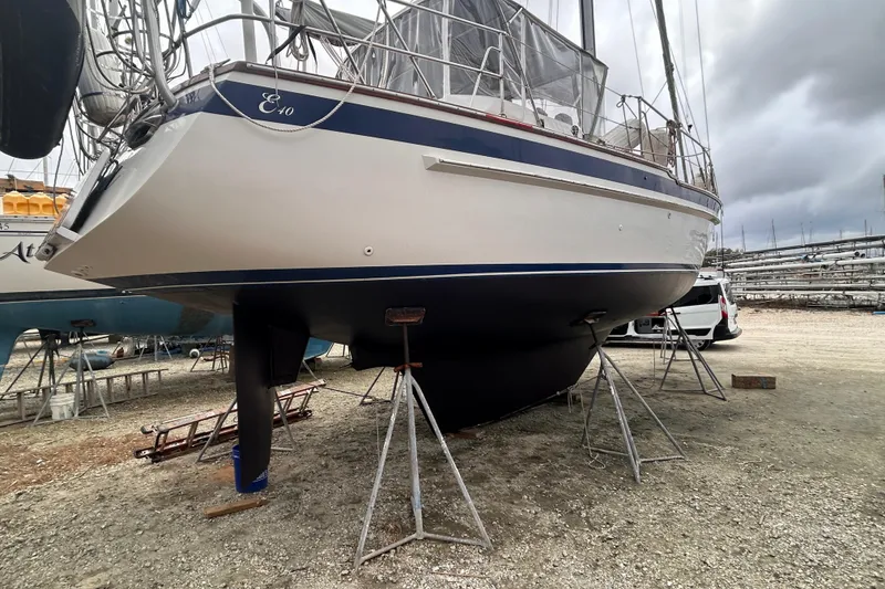 Slide: The Image of 1984 Endeavour 40 CC sailboat on stands in a boatyard, overcast sky. - 5