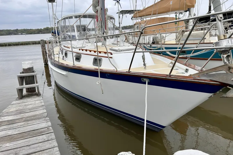 Slide: The Image of 1984 Endeavour 40 CC sailboat docked, featuring sleek design and classic nautical elements. - 8