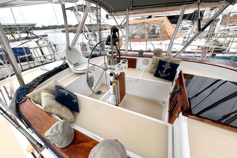 Slide: The Image of Cockpit of 1984 Endeavour 40 CC sailboat with helm, seating, and nautical decor. - 9