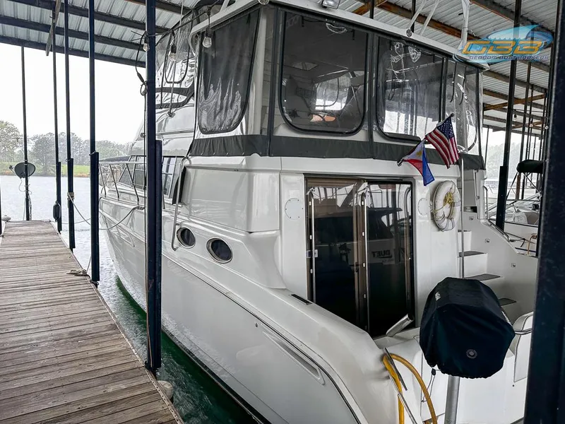 Slide: The Image of 1996 Silverton 442 Cockpit Motor Yacht docked, side view. - 10