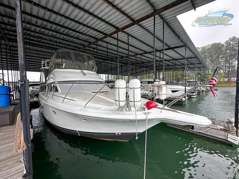 Slide: The Image of 1996 Silverton 442 Cockpit Motor Yacht docked in covered marina. - 12