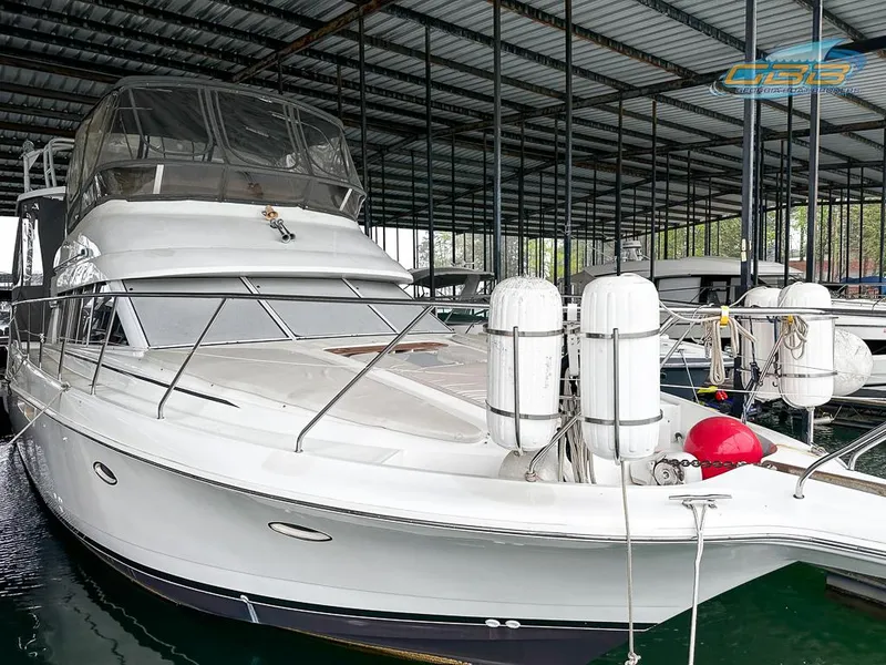 Slide: The Image of 1996 Silverton 442 Cockpit Motor Yacht docked in marina. - 13