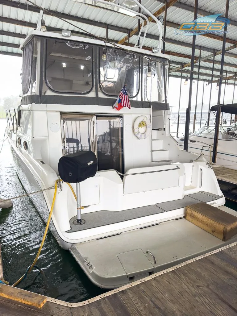 Slide: The Image of 1996 Silverton 442 Cockpit Motor Yacht docked in marina. - 17