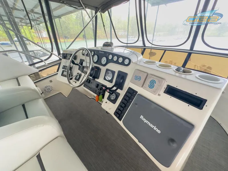 Slide: The Image of Interior view of 1996 Silverton 442 Cockpit Motor Yacht helm. - 21