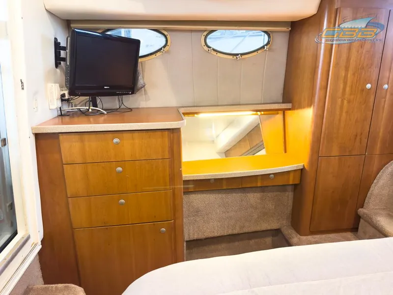 Slide: The Image of 1996 Silverton 442 Cockpit Motor Yacht interior with cabinets and TV. - 26