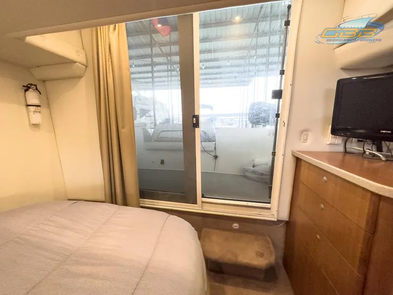 Slide: The Image of Interior of 1996 Silverton 442 Cockpit Motor Yacht with bed and sliding door. - 30