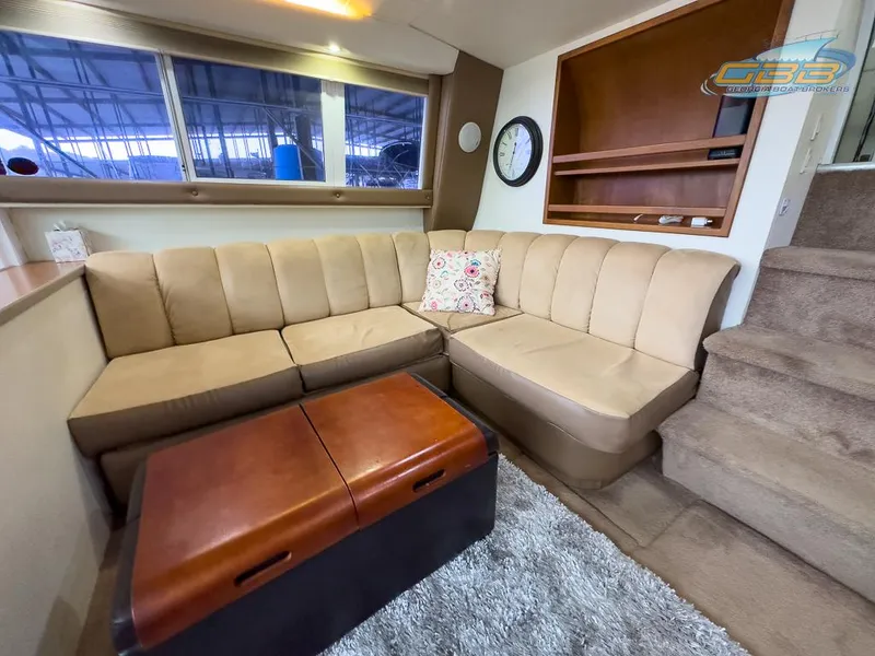 Slide: The Image of Interior of 1996 Silverton 442 Cockpit Motor Yacht with beige sofa and carpet. - 40