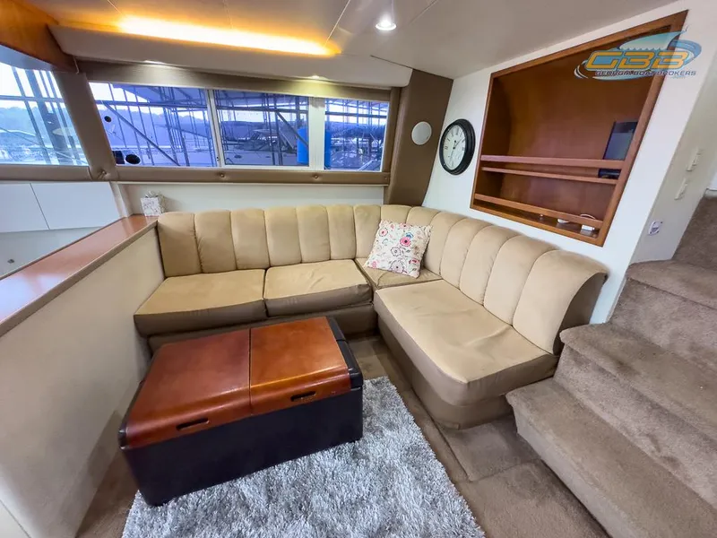 Slide: The Image of Interior of 1996 Silverton 442 Cockpit Motor Yacht with beige sofa and carpet. - 41