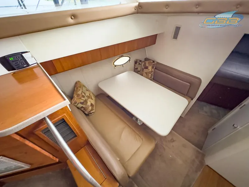 Slide: The Image of Interior of 1996 Silverton 442 Cockpit Motor Yacht with dining table. - 43