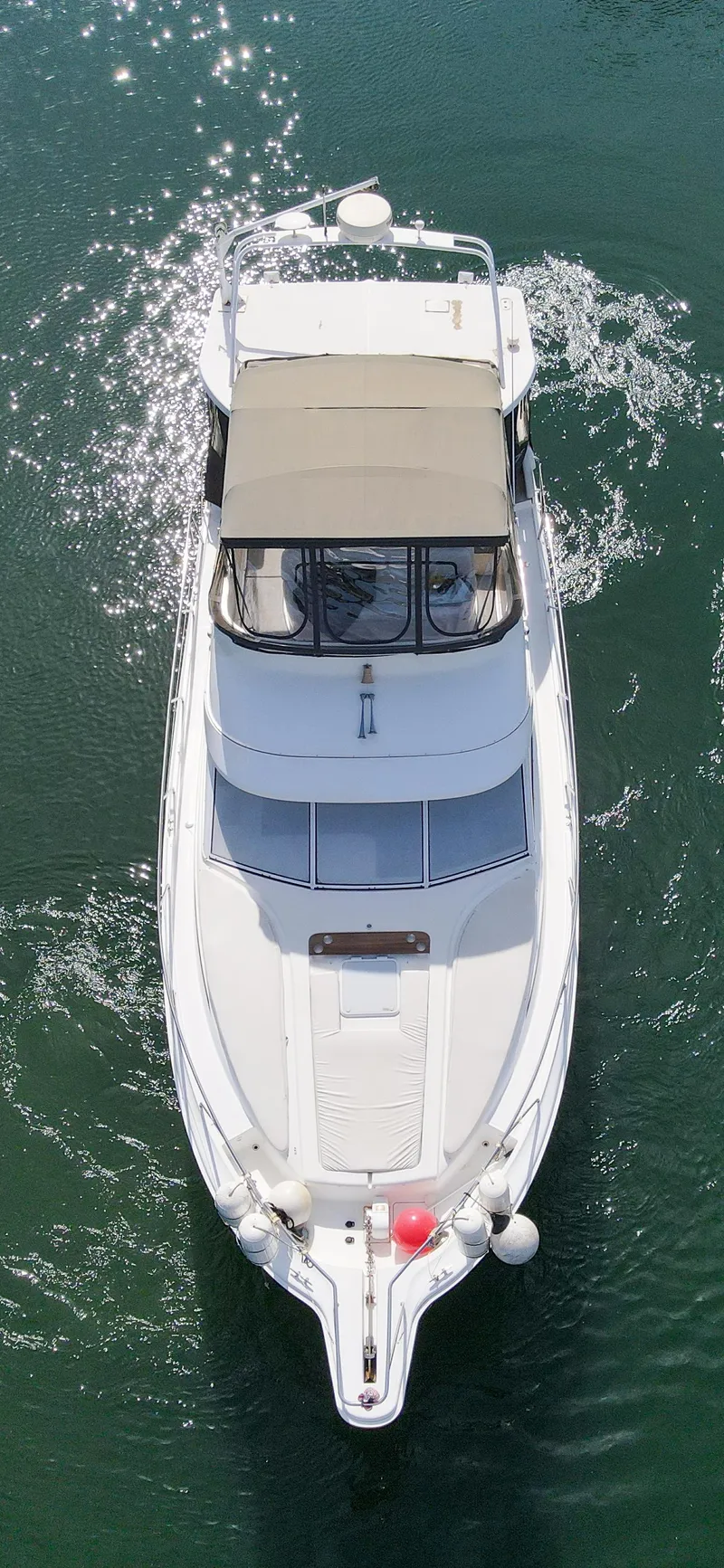 Slide: The Image of Aerial view of a 1996 Silverton 442 Cockpit Motor Yacht on water. - 6